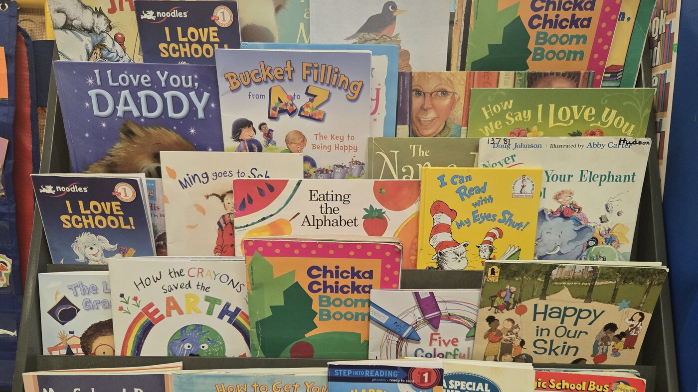 A front-facing rack of picture books in the Apple Valley preschool room
