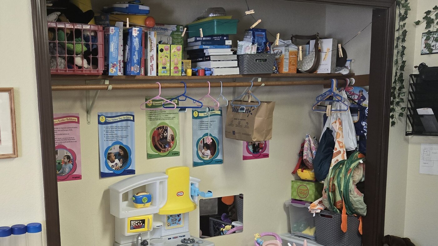 Coat hooks, cubby storage and a play kitchen in the Apple Valley toddler room