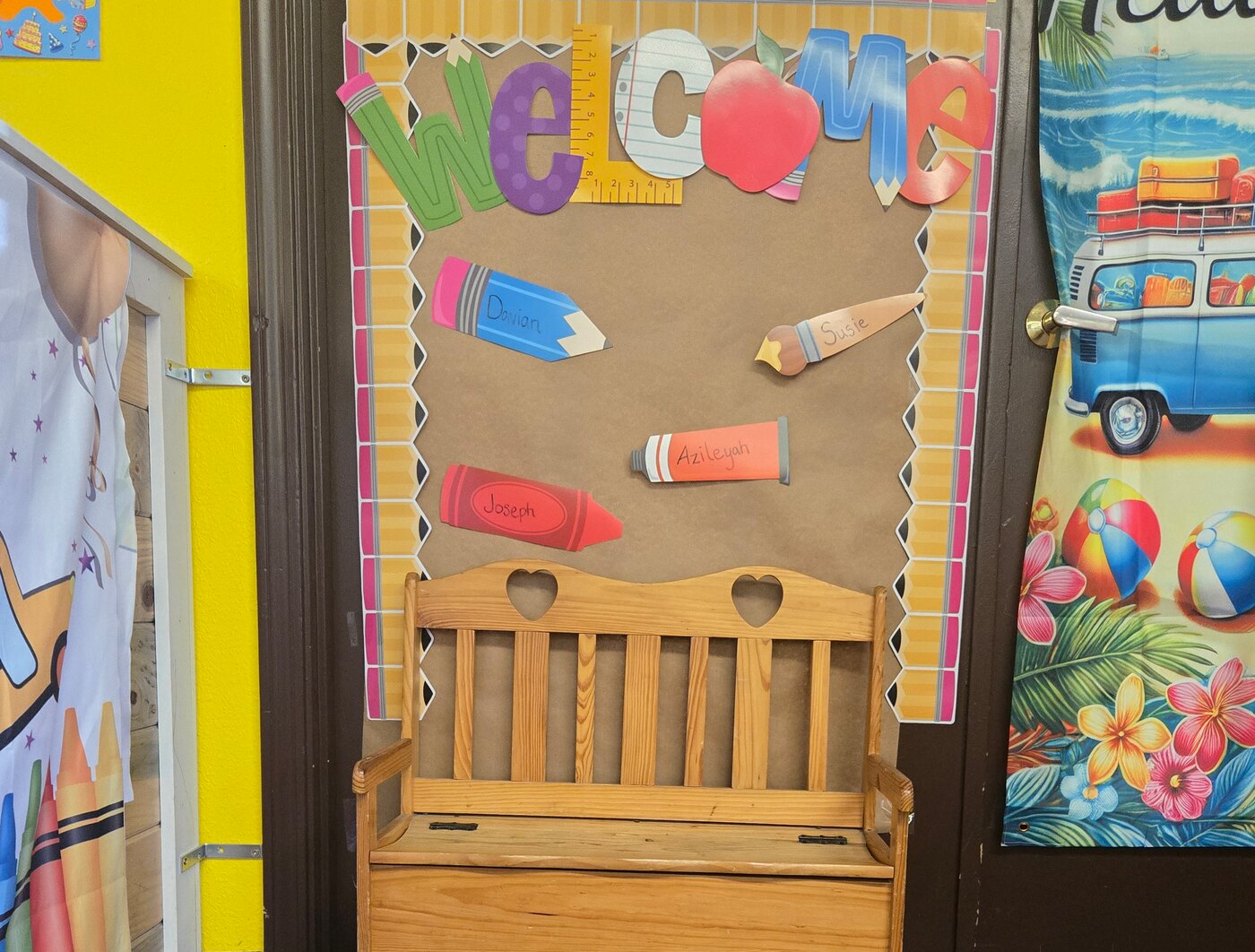 The welcome board and bench inside the Apple Valley entryway